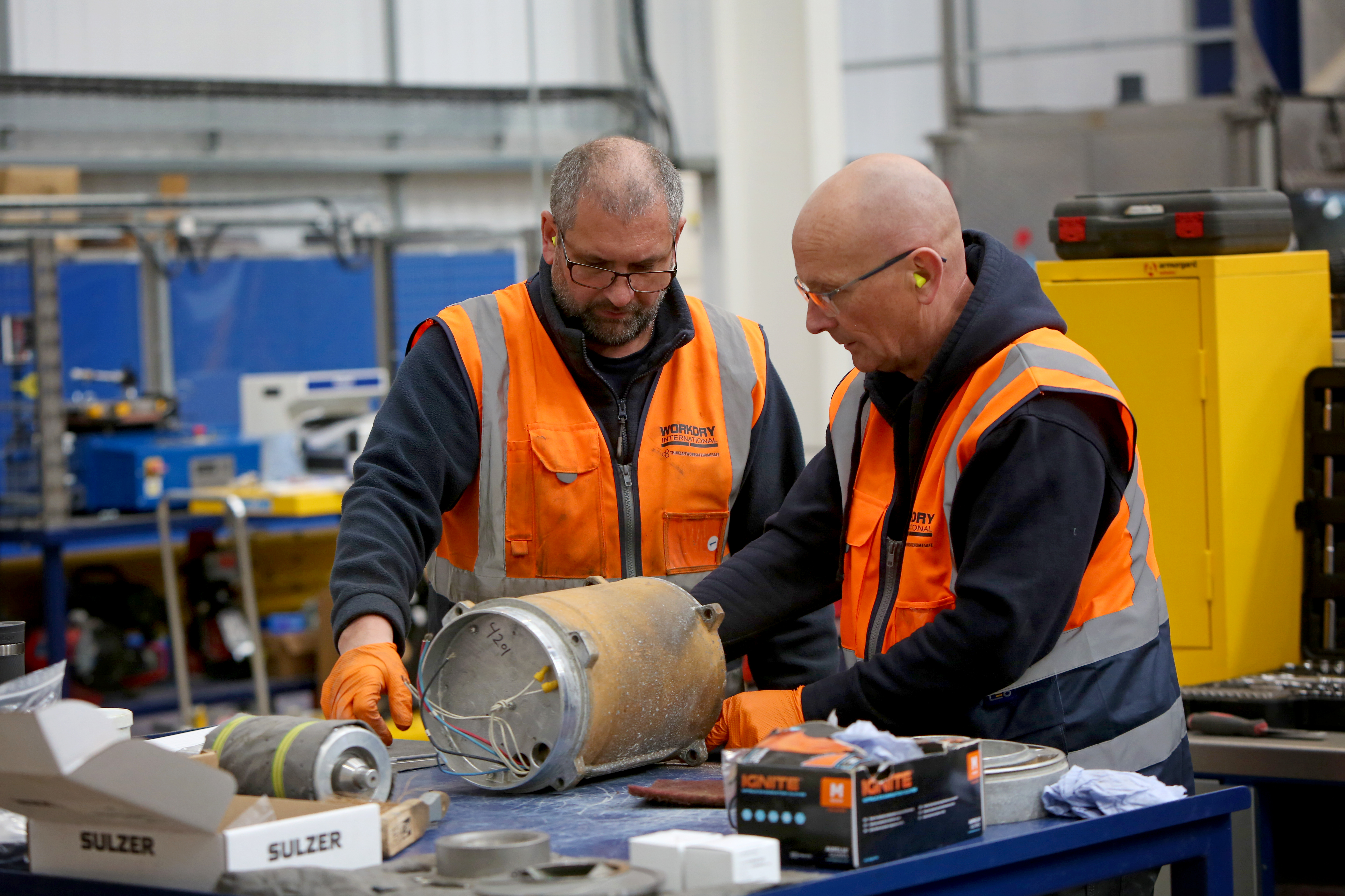 Jan 26 - 2 People at Workshop Bench Pump Part.jpg